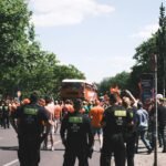 Police officers oversee a peaceful city demonstration on a sunny day.